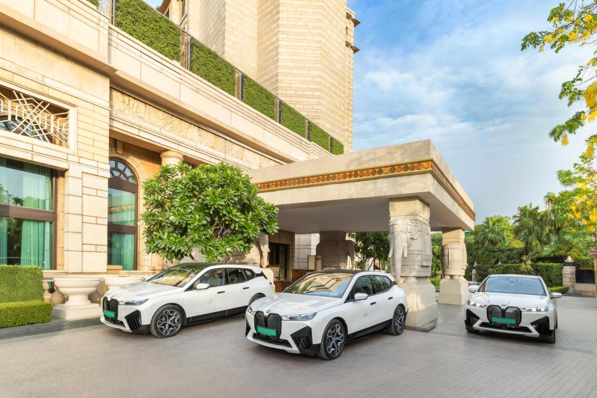 three white cars parked in front of a building at The Leela Palace New Delhi in New Delhi three white cars parked in front of a building at The Leela Palace New Delhi in New Delhi