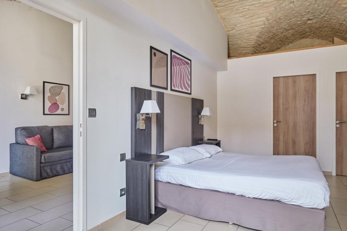 Un ou plusieurs lits dans un hébergement de l'établissement Appart'hôtel Odalys City - Dijon Centre Les Cordeliers