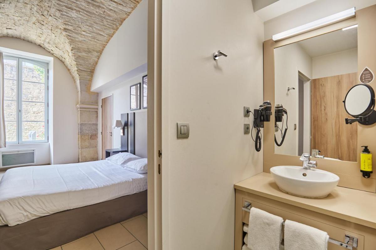 Un ou plusieurs lits dans un hébergement de l'établissement Appart'hôtel Odalys City - Dijon Centre Les Cordeliers