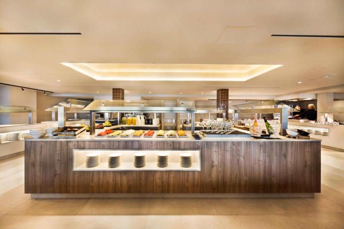 Un restaurante con un buffet de comida en exhibición. en Inmood Aucanada 4 Sup, en Puerto de Alcudia