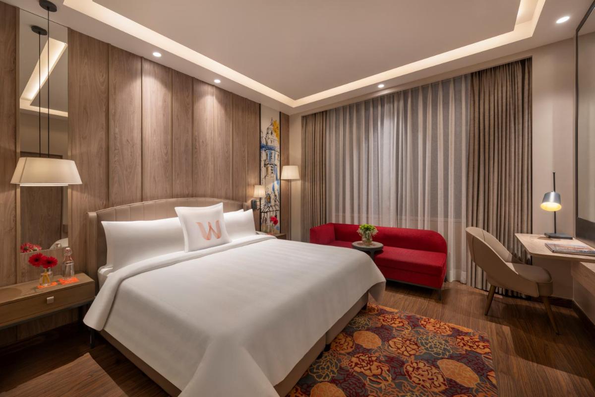 a bedroom with a large white bed and a desk at Welcomhotel by ITC Hotels, Delhi-Gurugram Highway in New Delhi