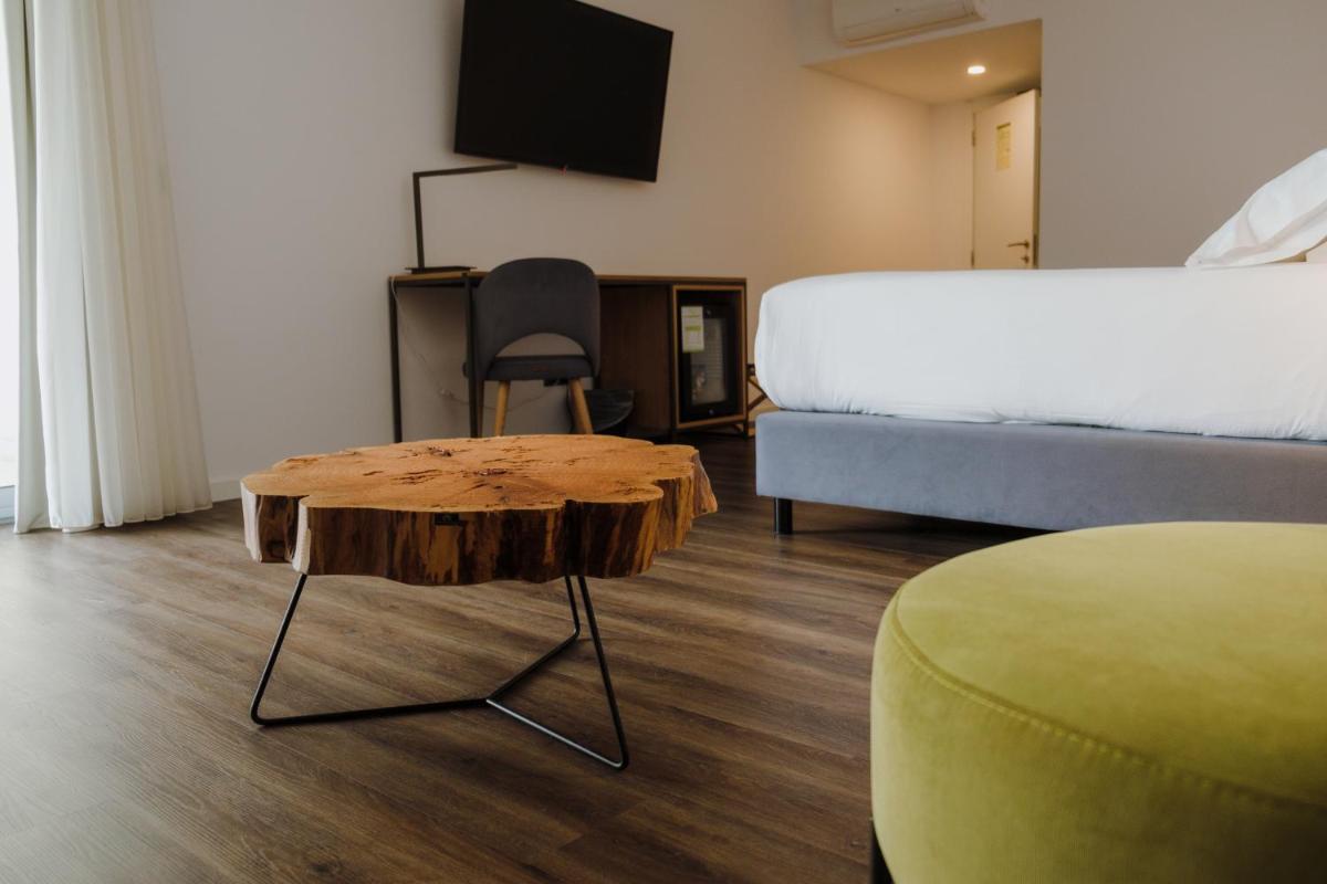 Uma cama ou camas num quarto em Monte Prado Hotel & Spa
