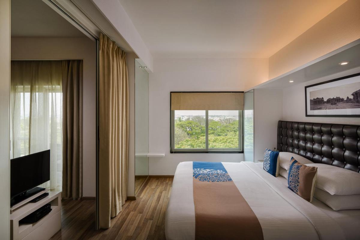 a bedroom with a large bed and a window at Grand Mercure Bangalore - An Accor Brand in Bengaluru
