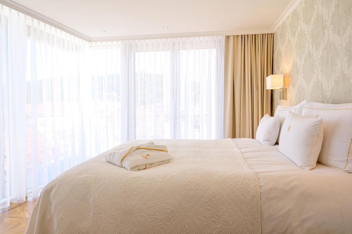 Ein Bett oder Betten in einem Zimmer der Unterkunft Colombi Hotel