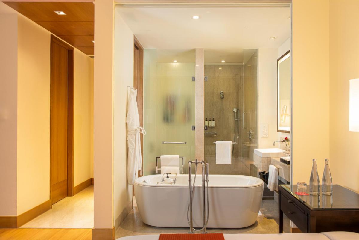 a large bathroom with a tub and a shower at Trident Hyderabad in Hyderabad