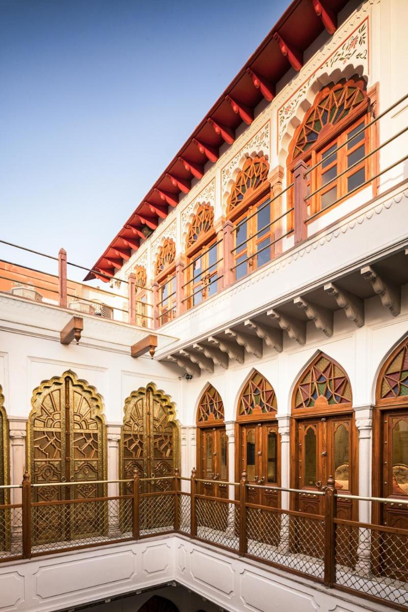 a building with ornate windows and a balcony at Haveli Dharampura & Golden Haveli- UNESCO awarded Boutique Heritage Hotel in New Delhi a building with ornate windows and a balcony at Haveli Dharampura & Golden Haveli- UNESCO awarded Boutique Heritage Hotel in New Delhi