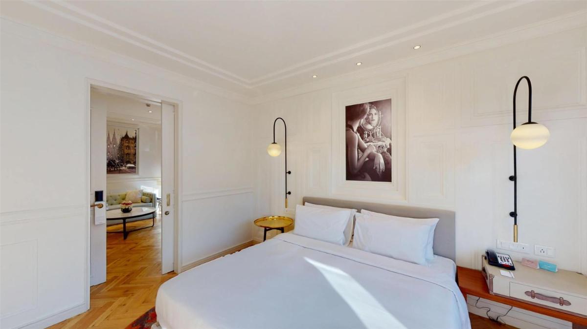 a bedroom with a large white bed in a room at Radisson Hotel Shimla in Shimla