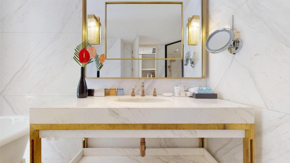 a bathroom with a sink and a mirror at Radisson Hotel Shimla in Shimla