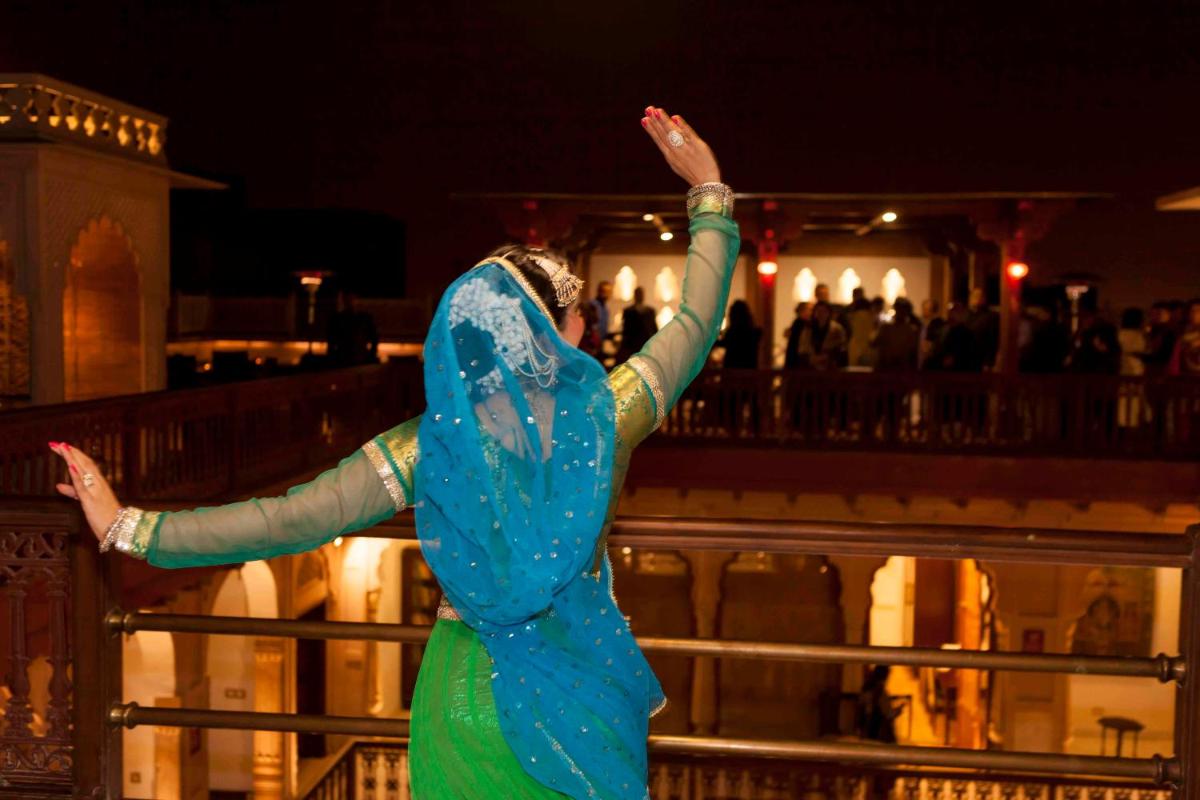 a woman in a blue and green dress dancing at Haveli Dharampura & Golden Haveli- UNESCO awarded Boutique Heritage Hotel in New Delhi a woman in a blue and green dress dancing at Haveli Dharampura & Golden Haveli- UNESCO awarded Boutique Heritage Hotel in New Delhi