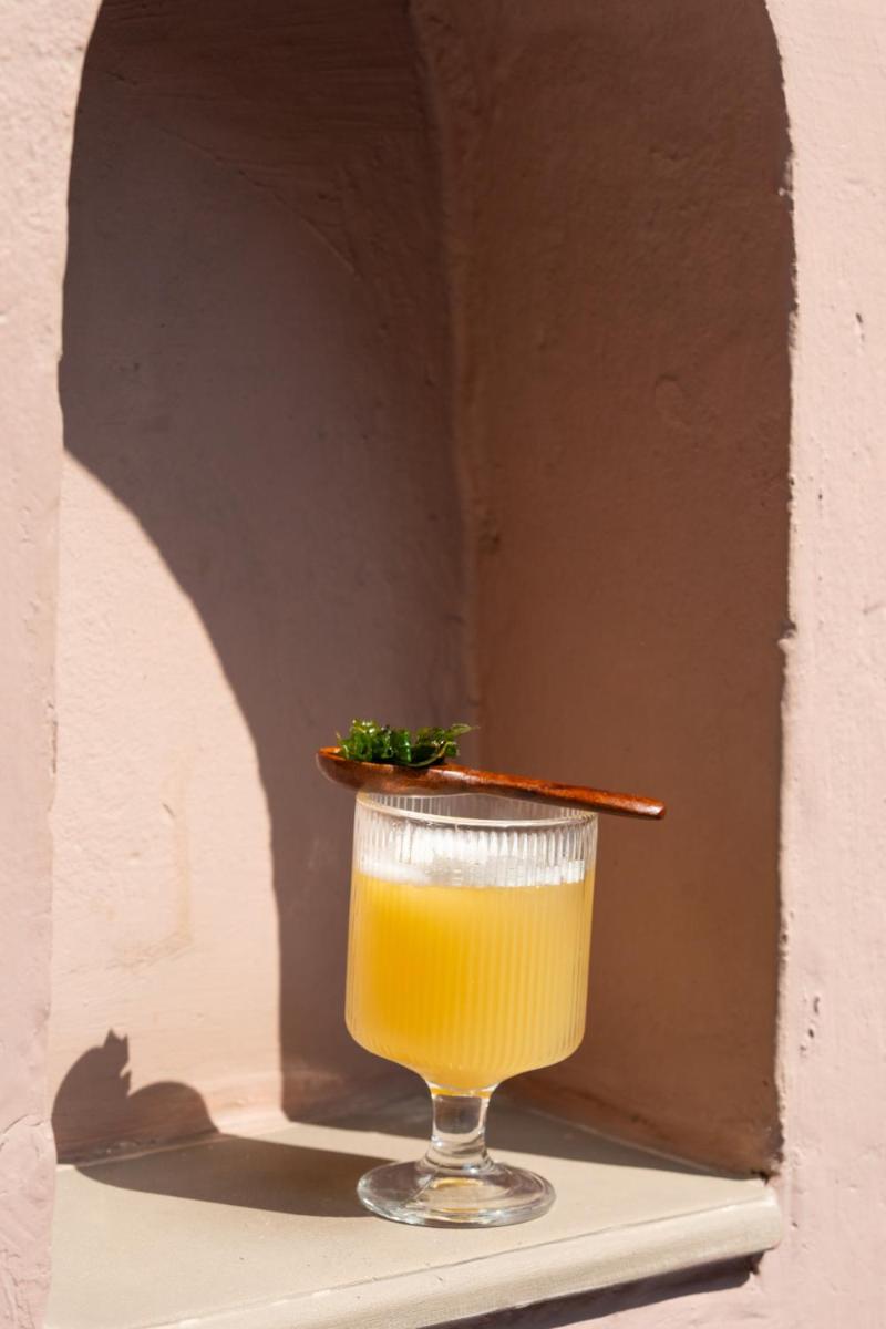 a glass of orange juice with a stick in it at Haveli Dharampura & Golden Haveli- UNESCO awarded Boutique Heritage Hotel in New Delhi a glass of orange juice with a stick in it at Haveli Dharampura & Golden Haveli- UNESCO awarded Boutique Heritage Hotel in New Delhi