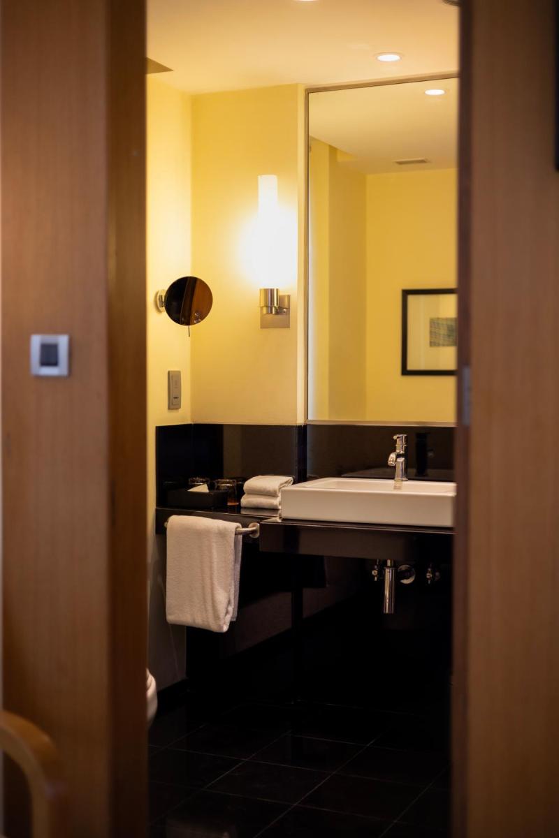 a bathroom with a sink and a mirror at Hyatt Hyderabad Gachibowli in Hyderabad