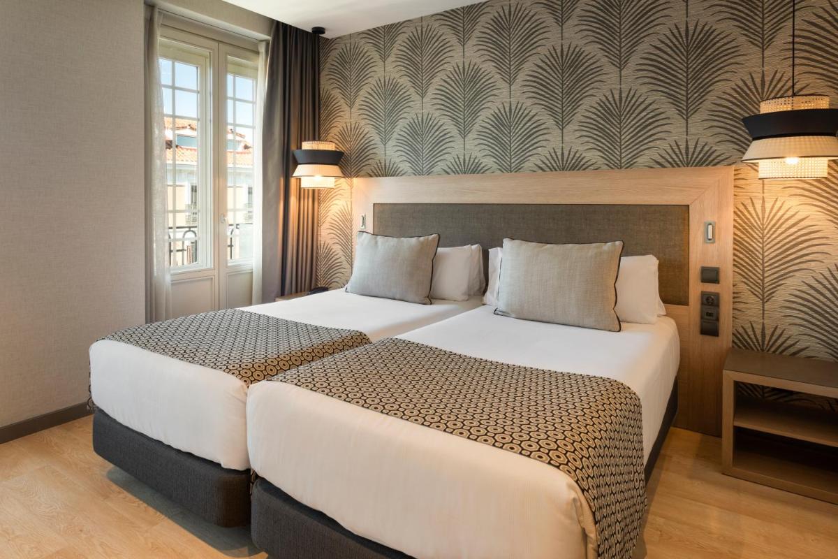 Cama o camas de una habitación en Catalonia Atocha