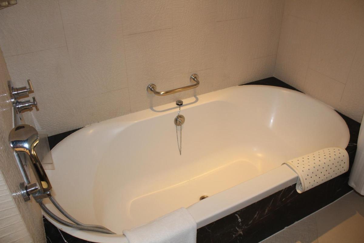 a white bath tub in a bathroom with at The Zuri Whitefield Bengaluru in Bengaluru