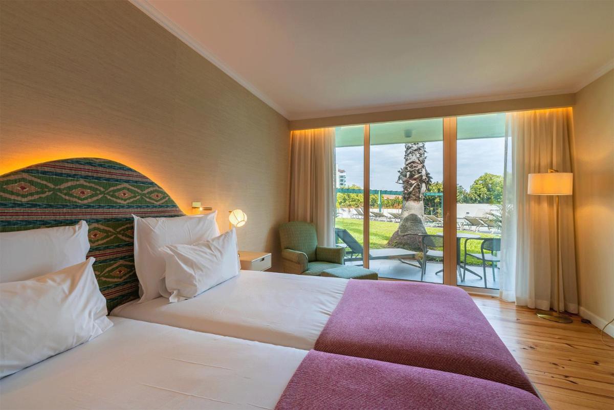 Uma cama ou camas num quarto em Pestana Quinta Perestrello