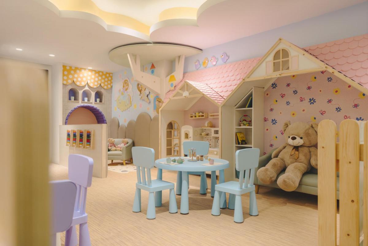 a childs bedroom with a teddy bear in a room at Fairmont Mumbai in Mumbai