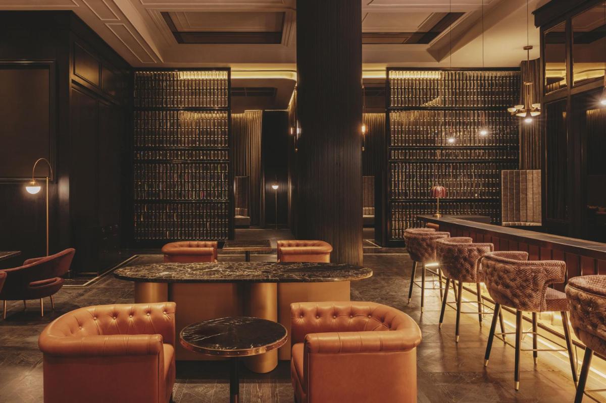 a bar with chairs and tables in a room at Fairmont Mumbai in Mumbai