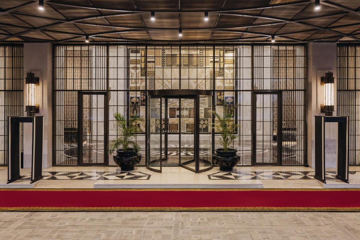 a lobby with potted plants and stained glass windows at Fairmont Mumbai in Mumbai