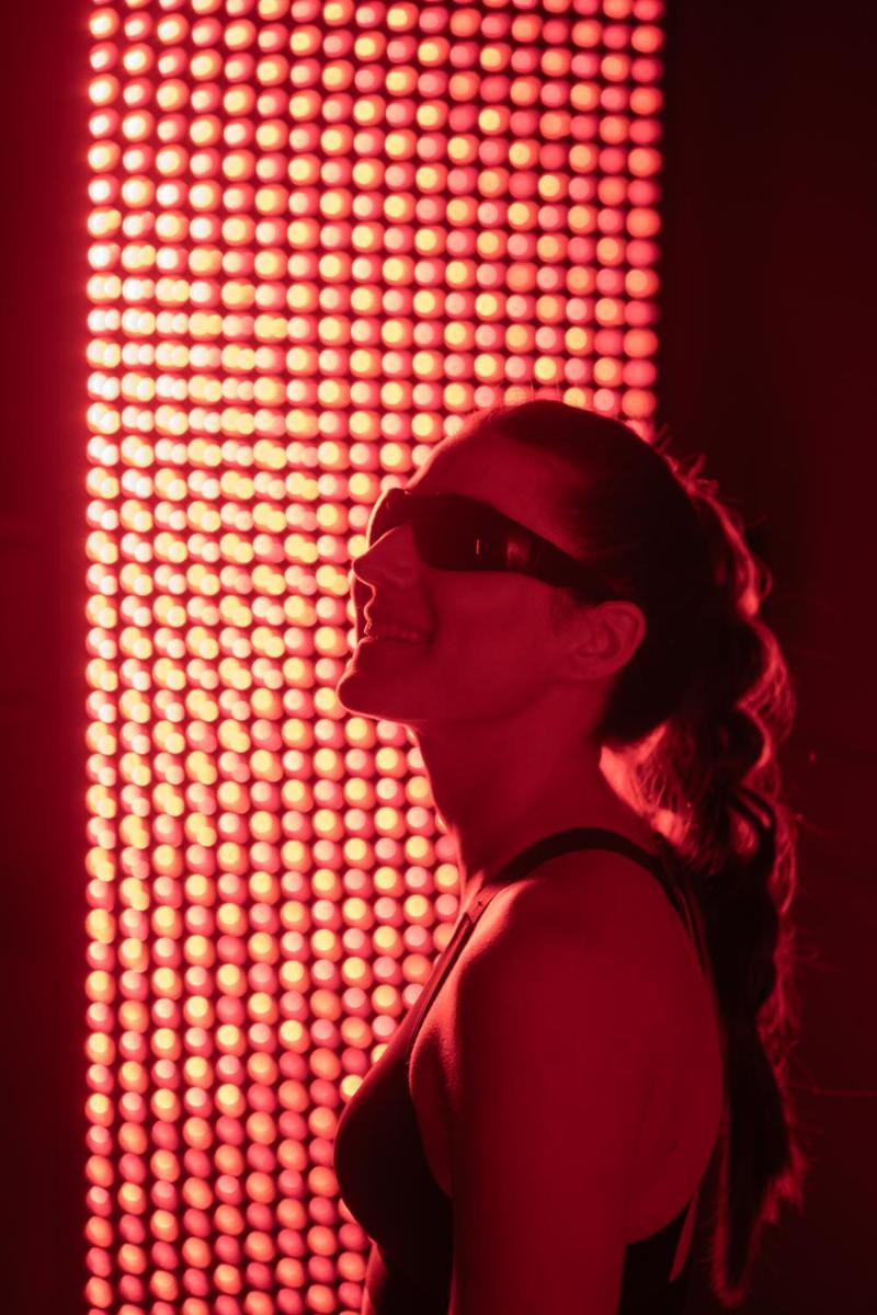 a woman standing in front of a wall of lights at Fairmont Mumbai in Mumbai