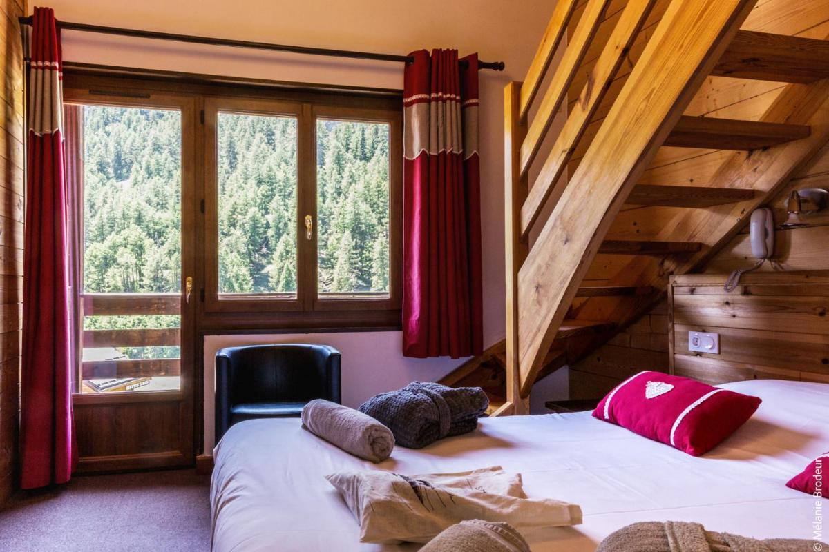Un ou plusieurs lits dans un hébergement de l'établissement Hotel Spa L'Equipe