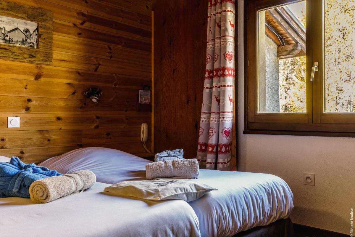 Un ou plusieurs lits dans un hébergement de l'établissement Hotel Spa L'Equipe
