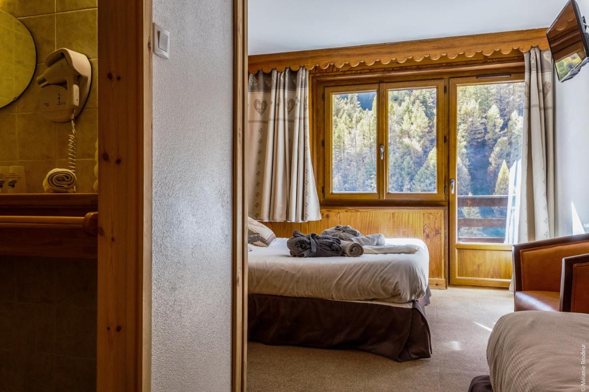 Un ou plusieurs lits dans un hébergement de l'établissement Hotel Spa L'Equipe