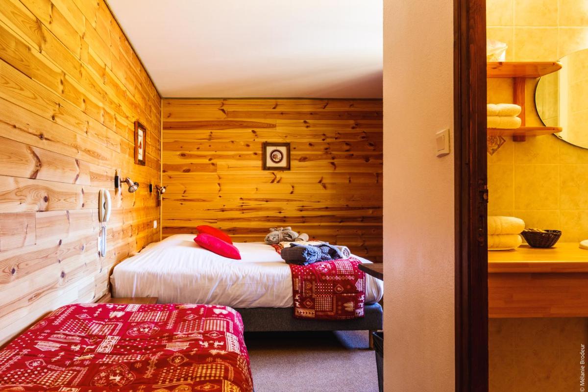Un ou plusieurs lits dans un hébergement de l'établissement Hotel Spa L'Equipe