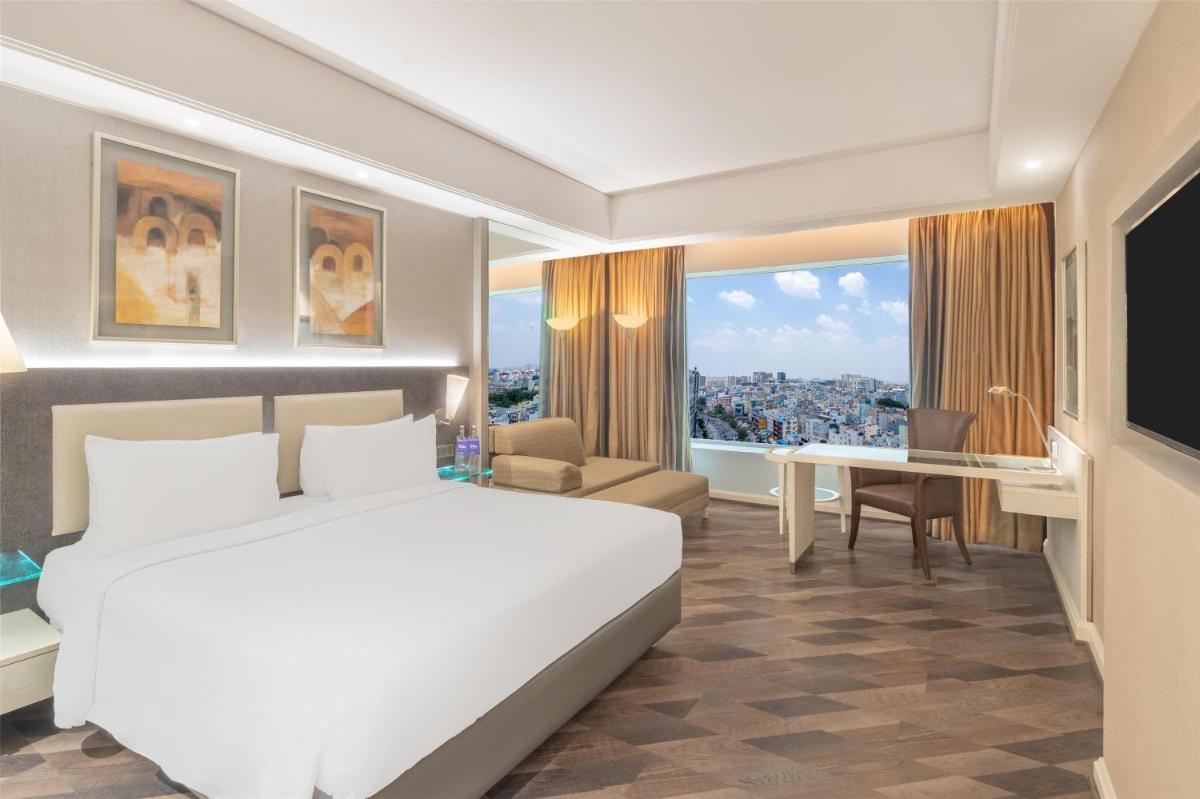 a hotel room with a bed and a desk at Radisson Hyderabad Hitec City in Hyderabad