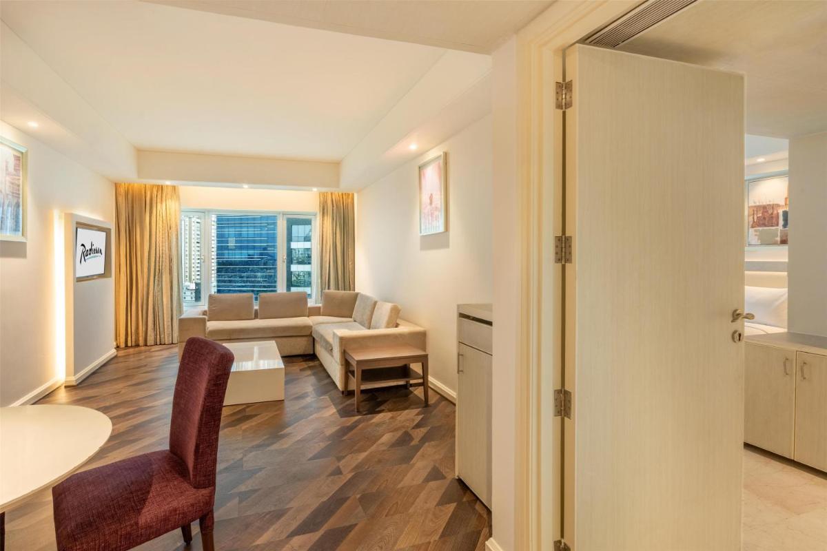a living room with a couch and a table at Radisson Hyderabad Hitec City in Hyderabad