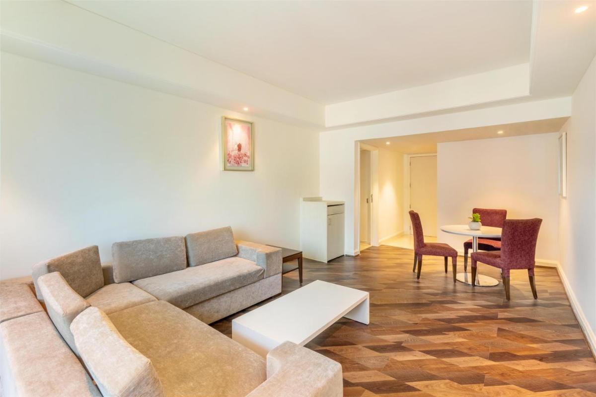 a living room with a couch and a table at Radisson Hyderabad Hitec City in Hyderabad
