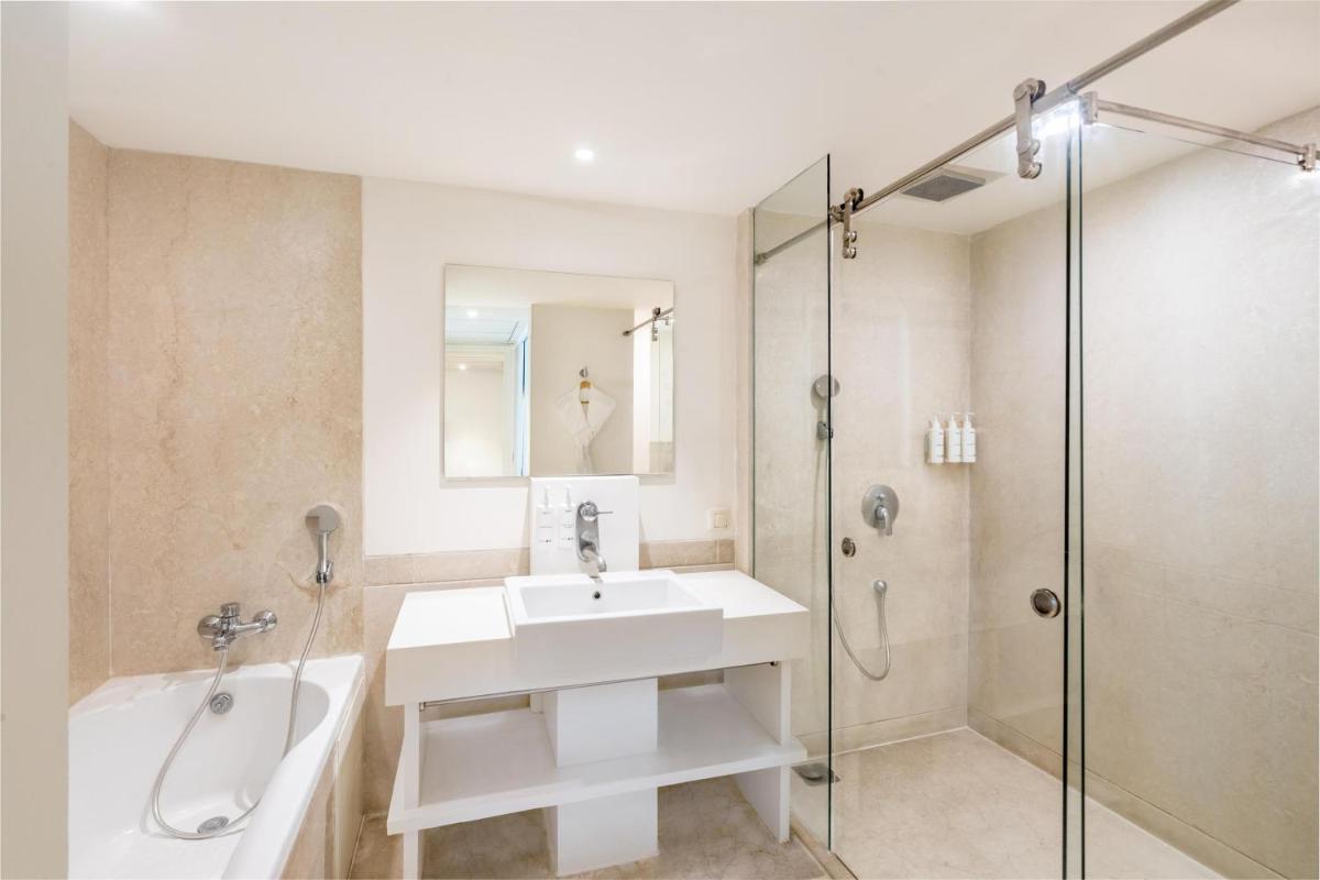 a bathroom with a tub and a sink and a shower at Radisson Hyderabad Hitec City in Hyderabad