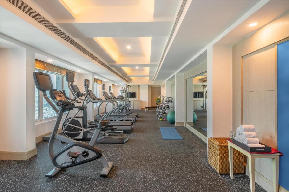 a row of treadmills in a gym with treadleys at Radisson Hyderabad Hitec City in Hyderabad