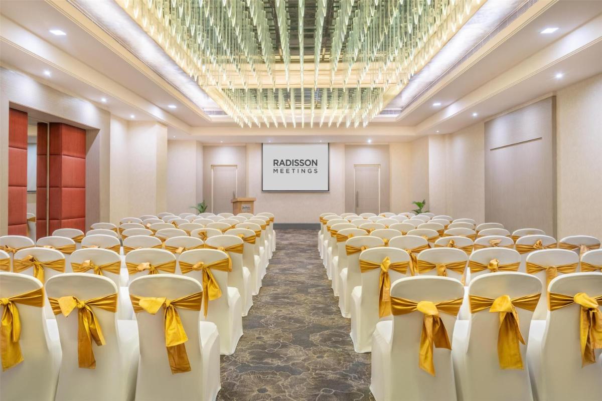 a room with rows of chairs with bows at Radisson Hyderabad Hitec City in Hyderabad