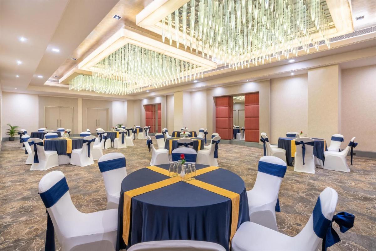 a banquet hall with blue and white tables and chairs at Radisson Hyderabad Hitec City in Hyderabad