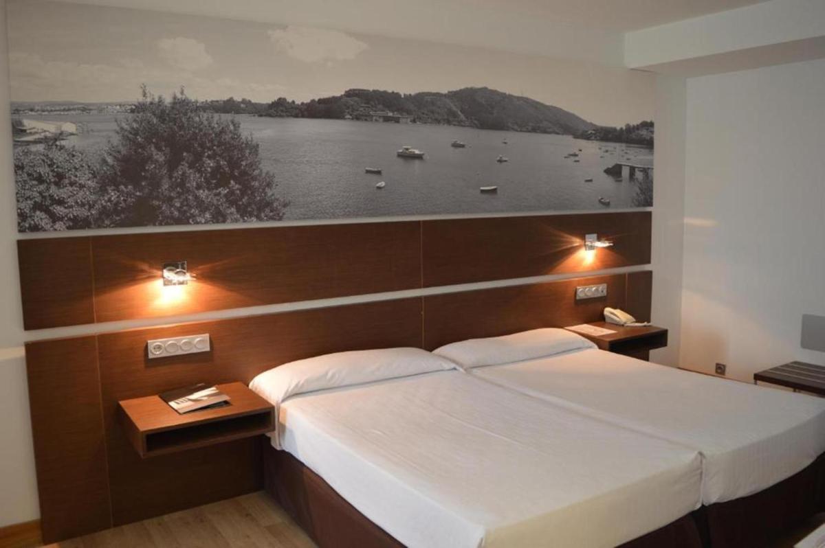Cama o camas de una habitación en Hotel Spa Odeón