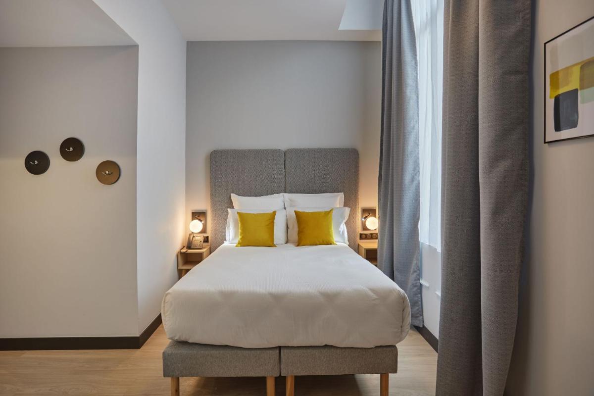 Un ou plusieurs lits dans un hébergement de l'établissement Appart'hôtel Odalys City - Nîmes Arènes - Palais des Congrès