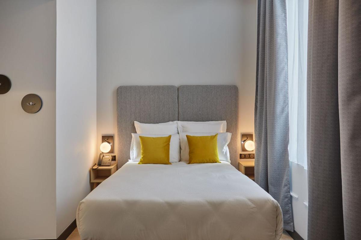 Un ou plusieurs lits dans un hébergement de l'établissement Appart'hôtel Odalys City - Nîmes Arènes - Palais des Congrès