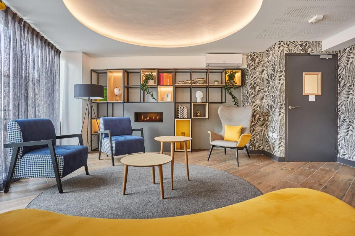 Coin salon dans l'établissement Appart'hôtel Odalys City - Nîmes Arènes - Palais des Congrès