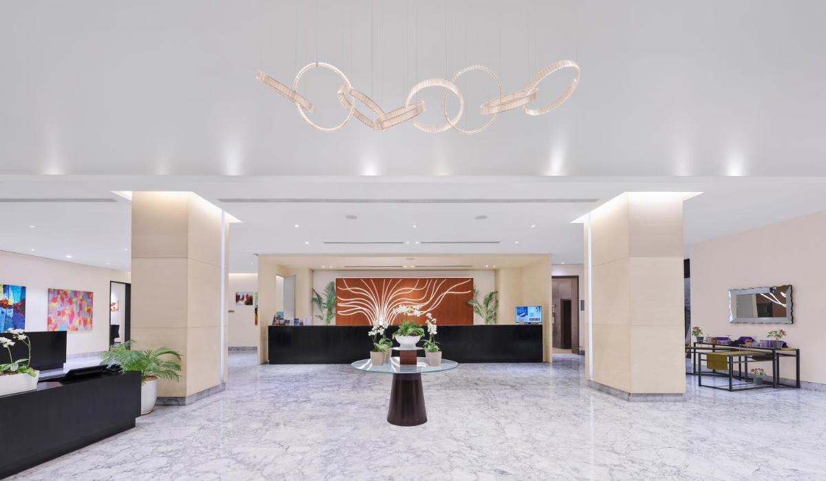 a lobby with a table in the middle of a building at Vivanta Pune, Hinjawadi in Pune