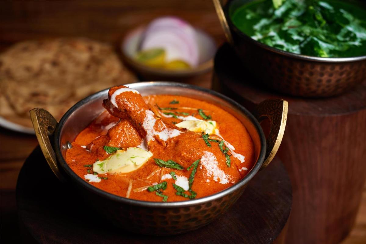 a bowl of tomato soup on a wooden table at Radisson Blu Mumbai International Airport in Mumbai a bowl of tomato soup on a wooden table at Radisson Blu Mumbai International Airport in Mumbai