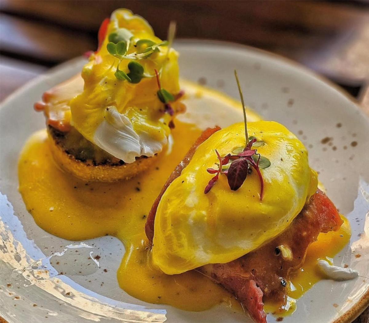 a plate of food withached eggs and sauce on it at Radisson Blu Mumbai International Airport in Mumbai a plate of food withached eggs and sauce on it at Radisson Blu Mumbai International Airport in Mumbai