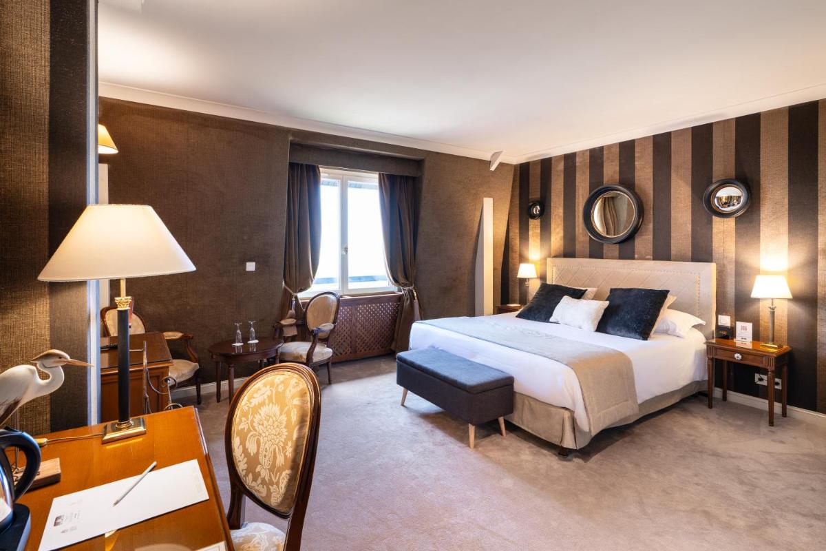 Un ou plusieurs lits dans un hébergement de l'établissement Le Manoir De La Poterie & Spa