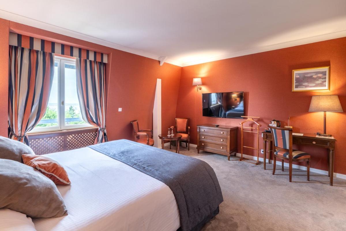 Un ou plusieurs lits dans un hébergement de l'établissement Le Manoir De La Poterie & Spa