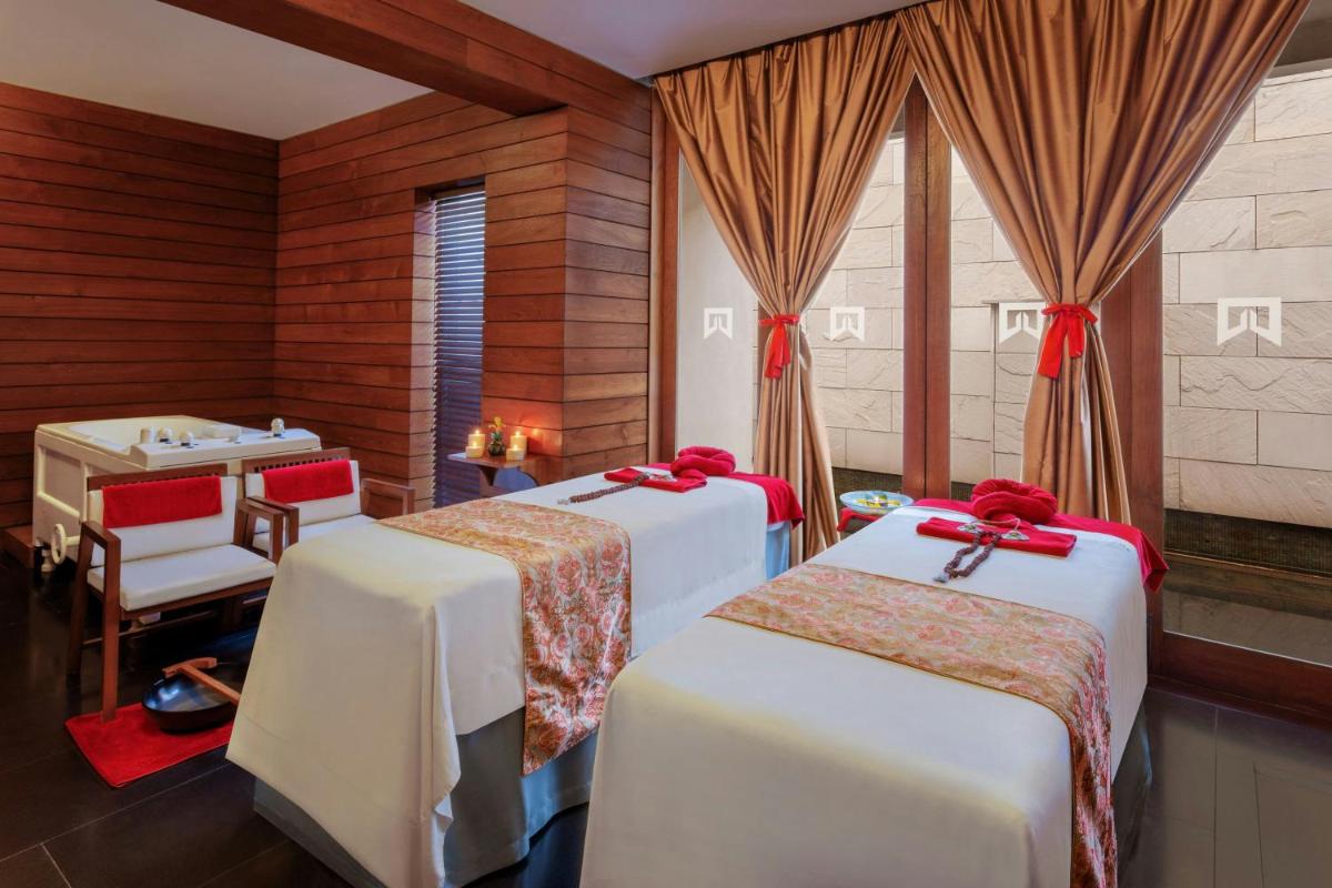 a room with three beds with red bows at ITC Sonar, a Luxury Collection Hotel, Kolkata in Kolkata
