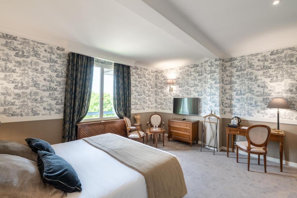 Un ou plusieurs lits dans un hébergement de l'établissement Le Manoir De La Poterie & Spa
