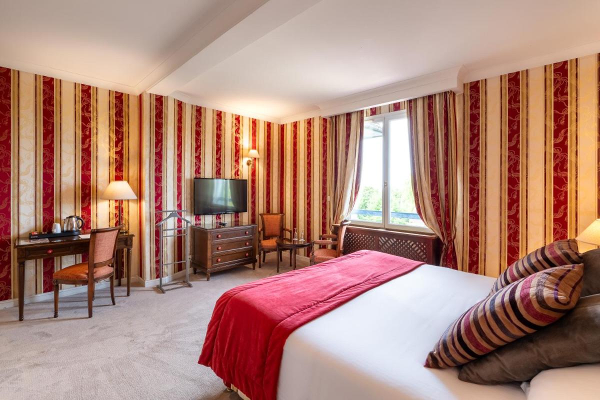 Un ou plusieurs lits dans un hébergement de l'établissement Le Manoir De La Poterie & Spa