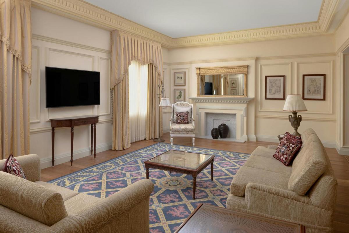 a living room with a couch and a tv at ITC Windsor, a Luxury Collection Hotel, Bengaluru in Bengaluru a living room with a couch and a tv at ITC Windsor, a Luxury Collection Hotel, Bengaluru in Bengaluru