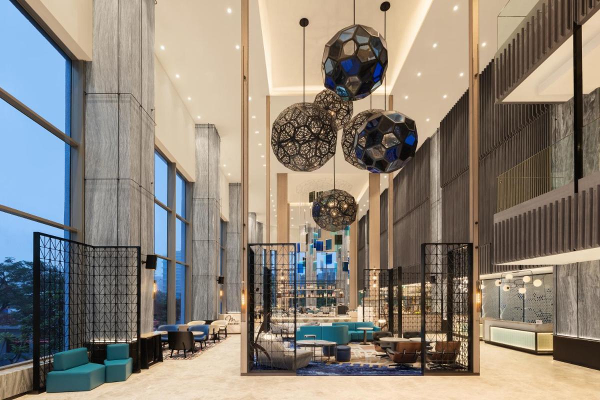 a view of the lobby of a building with windows at Le Meridien Ahmedabad in Ahmedabad