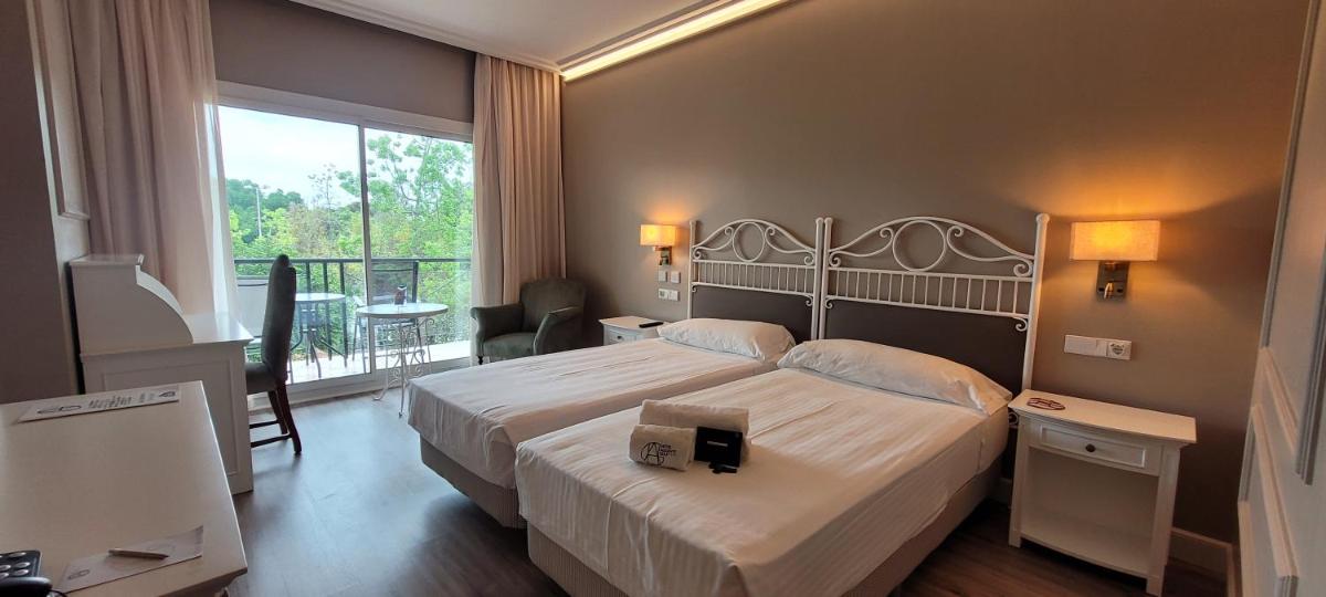 Cama o camas de una habitación en Hotel Alicante Golf