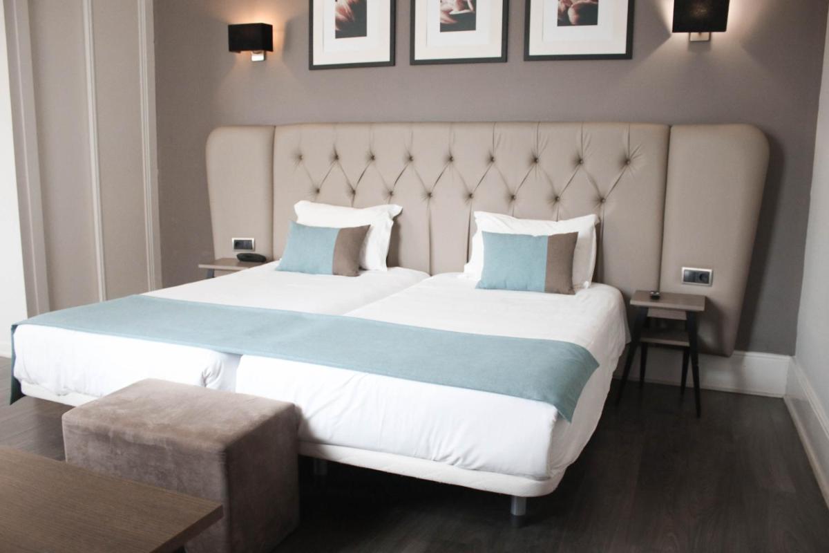 Uma cama ou camas num quarto em Hotel Bienestar Termas De Vizela