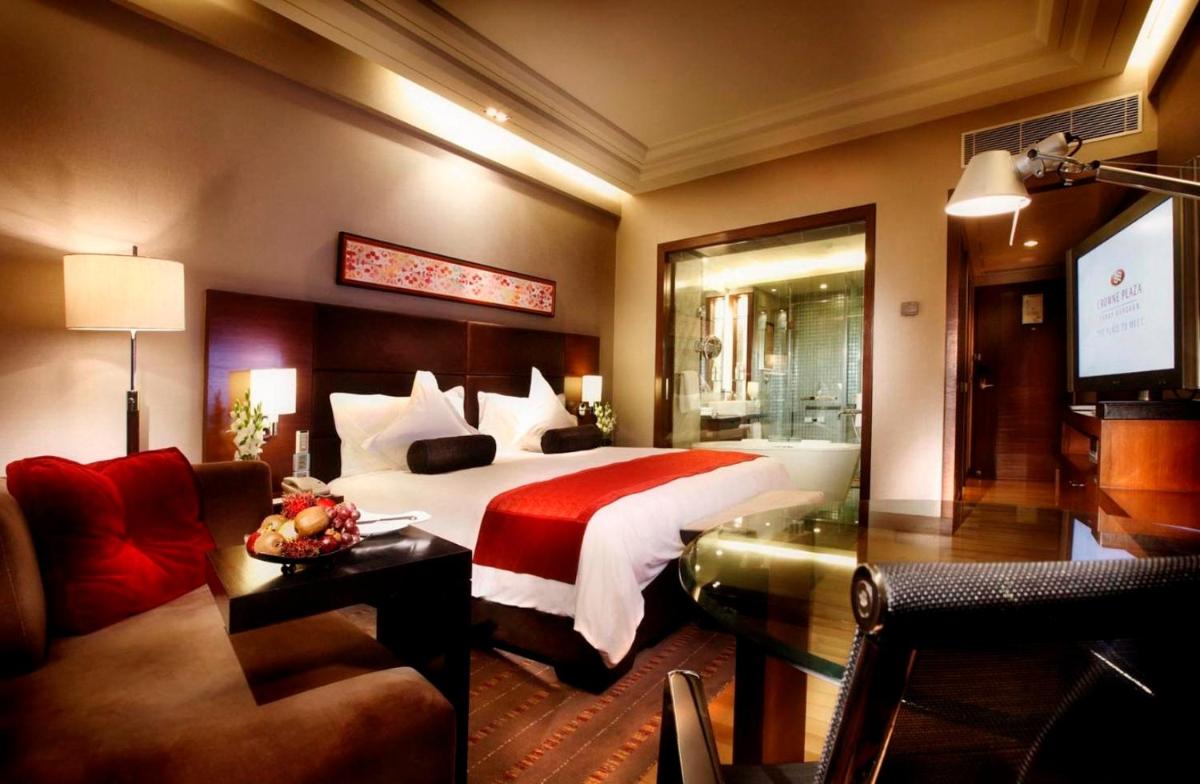 a hotel room with a bed and a couch at Crowne Plaza Today Gurugram by IHG in Gurgaon